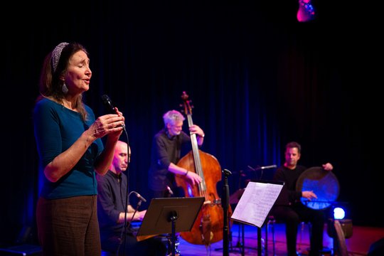 Jazzband auf der Bühne, im Vordergrund eine Sängerin mit Mikro